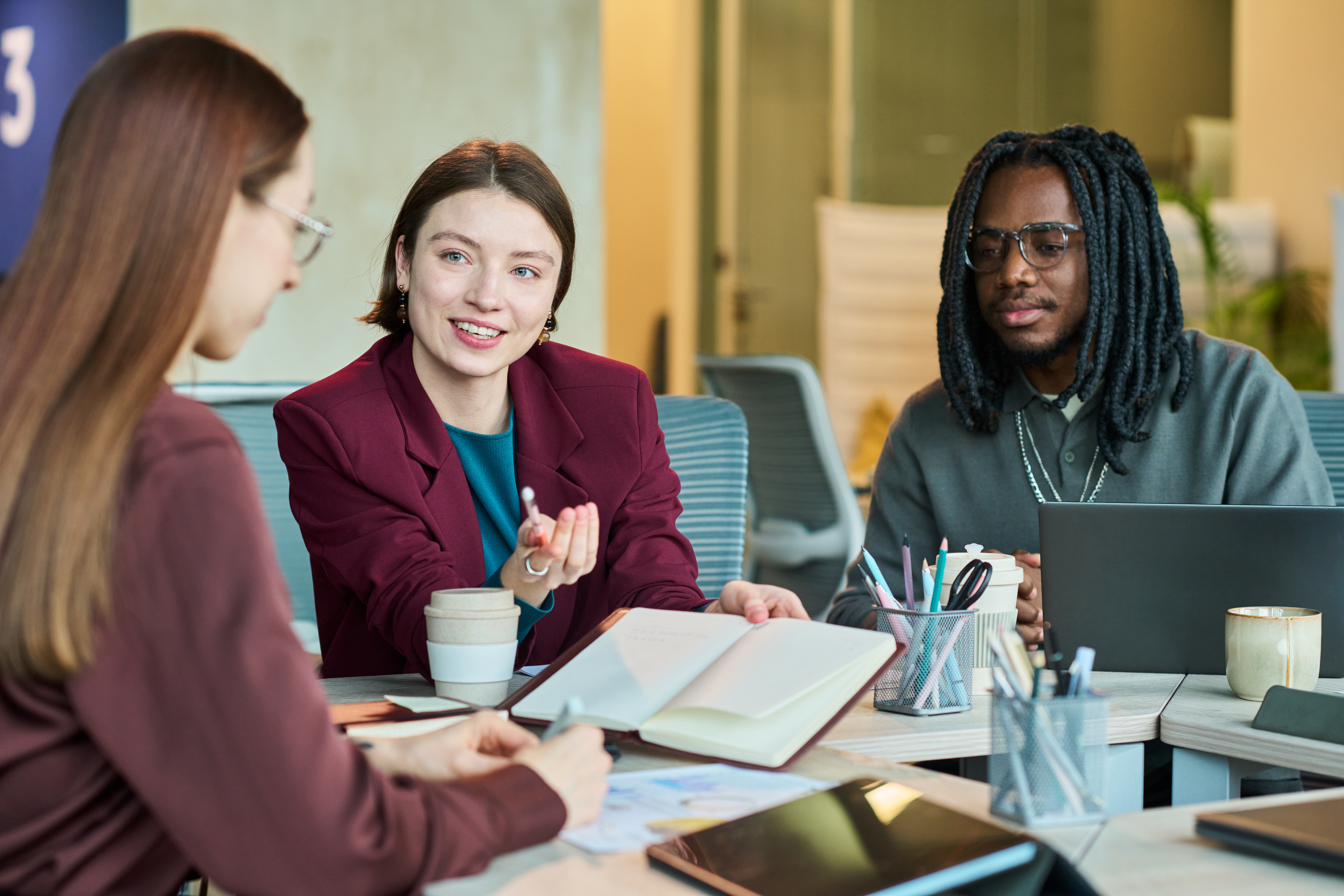 Two seasoned professional having a peer mentorship with a newly hired employee.
